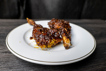 Sego Bebek or Bebek Madura. Popular Indonesian food of deep-fried duck, photographed on white plate