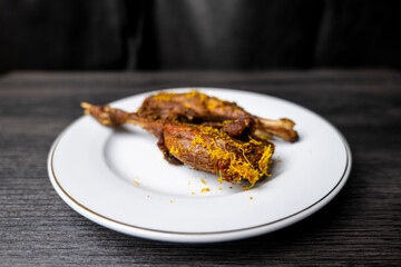 Sego Bebek or Bebek Madura. Popular Indonesian food of deep-fried duck, photographed on white plate