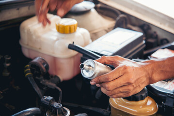 Close up Car Mechanic man hands repairing car auto repair shop. Man hands fixing machinery vehicle mechanical service. open vehicle hood checking up auto mobile. Vehicle Car maintenance engineer.