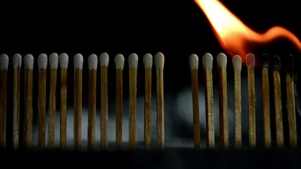 burning match on black background
