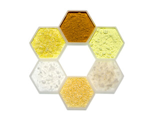 Chemical ingredient in hexagonal molecular shaped container. Curcuma Powder, Sulfur Powder, Flake Salt, Candelilla Wax, Cetyl Esters Wax and Sodium Sulfide Flakes.