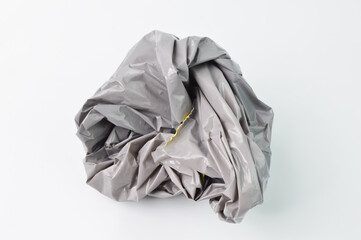 Grey crumpled plastic isolated on a white background