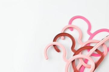 Colorful plastic hangers isolated on a white background