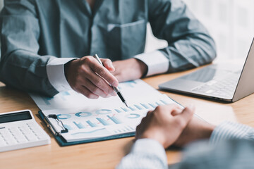 Business people discussing contract working together at meeting in modern office. Unknown businessman and woman with colleagues or lawyers at negotiation
