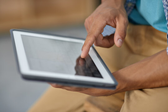 Unlock the world with a touch of your hand. Cropped image of someone working on a digital tablet - closeup.