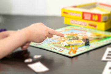 hand pick board game by child with fun