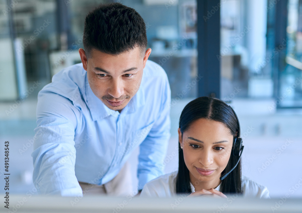 Poster passing the torch of customer service expertise. shot of a young man helping his colleague in a mode
