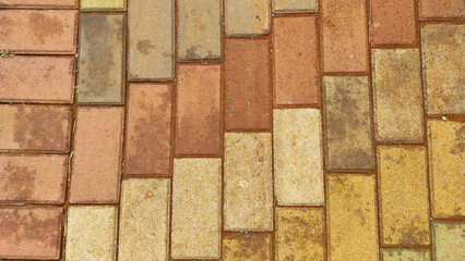 Textured background of paving blocks on red soil in the tourist area of Cicalengka