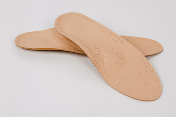 Insoles isolated on a white background. Medical orthopedic insoles. Foot care. Insole cutaway layers. Treatment and prevention of flat feet and foot diseases. Inner soles of shoes
