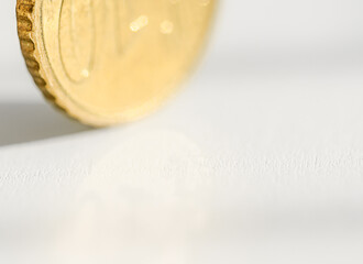 Golden coin on light background with copy space