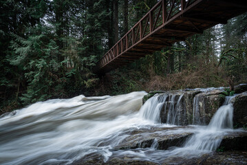 Hiking bridge over powerful flowing creek in Camas, Washington State, Pacific Northwest