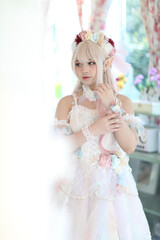 Beautiful young woman with white lolita dress with flowers garden Japanese fashion