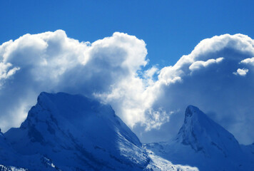Magical winter clouds over snowy peaks of the Swiss alpine mountain range Churfirsten (Churf&uuml;rsten or Churfuersten) in the Appenzell Alps massif - Unterwasser, Switzerland (Schweiz)