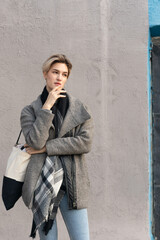 Obraz premium young beautiful woman pose in a coat in the city