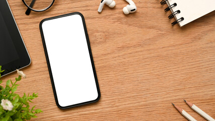A telephone white empty screen mockup on minimal wooden desk