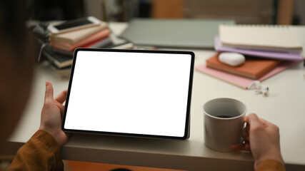 Female reading and analysing the data at tablet screen