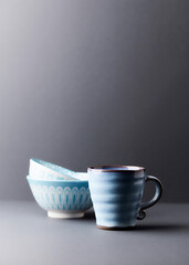 Traditional, handcrafted ceramic on gray background. Soft focus. Copy space.