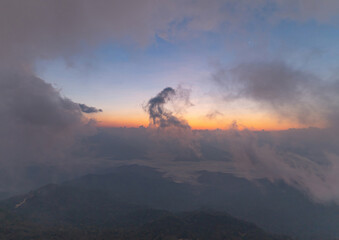 Naklejka na ściany i meble Aerial top view of forest trees and green mountain hills with fog, mist and clouds. Nature landscape background, Thailand.