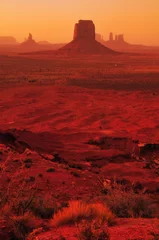 Wall murals Rood violet Blood red sunset bathing the buttes and mesas of Monument Valley Navajo Tribal Park from the Artist's Point viewpoint, Arizona, USA
