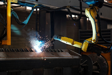 Arc welding of part of huge iron industrial automated machine during process of repairing inside...