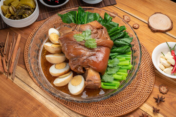 Asian food, Stewed Pork Leg Recipes and egg with five spices  served with blanched kale, black soy sauce, garlic and  fresh chili.