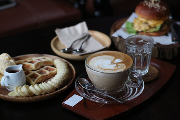 Beef burger served with Tuna toast, potato fries, blueberry waffle and hot coffee