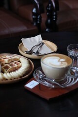 Beef burger served with Tuna toast, potato fries, blueberry waffle and hot coffee