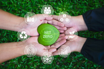 Net zero and carbon neutral concept. Hands adult Teamwork harmony Holding heart leaf on hands with...