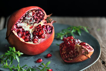 pomegranate on a plate on a wooden board