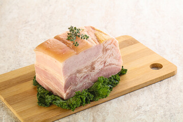 Cut of pork bacon over board