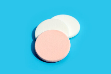 Sponge for face make-up cleaning on blue background