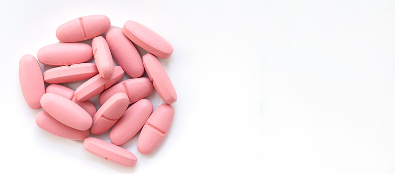 Banner of pink pills isolated on white background top view