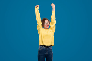 Delighted woman celebrating success in studio