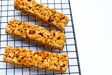 Peanut bar with almonds on metal cooling rack
