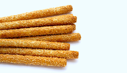 Sesame breadsticks on white background.