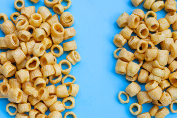 Crispy potato rings on blue background.