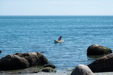 Women paddles her kayak towards the beach