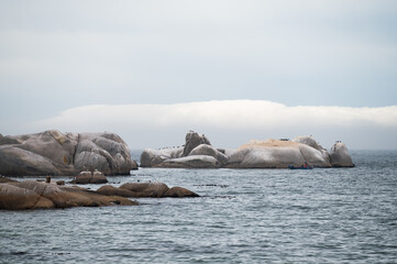 Ocean boulders with clouds in the background