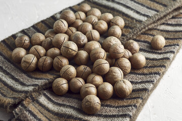 macadamia nuts on a canvas with a traditional African ornament