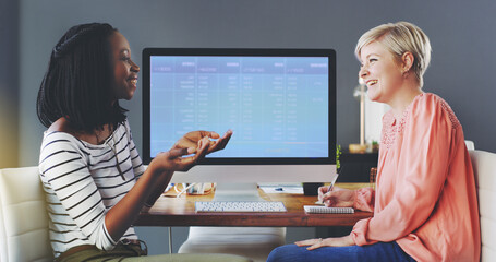 Their big ideas are slowly coming together. Shot of two businesswomen brainstorming together in an...