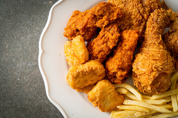 fried chicken with french fries and nuggets on plate