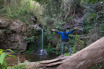 hiker in the forest at waterfall 