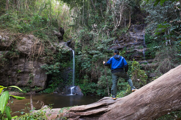 hiker in the forest at waterfall 