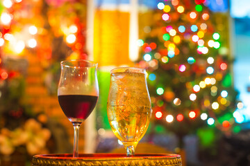 glasses of wine and whisky on Christmas background