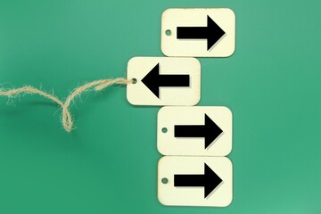 wooden tags with arrows one in a different direction and another in a different direction. the...