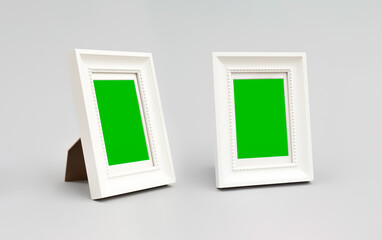 Green Screen. Two white photo frames. Isolated with gray background.