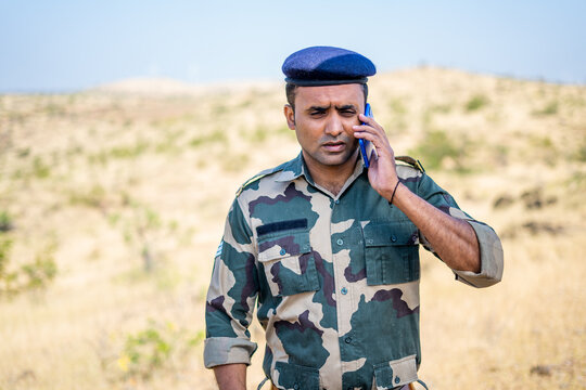 Panic soldier while talking on mobile phone during miliary service - concept of stressful, healthcare and professional occupation