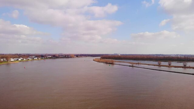 Aerial Flying Over Oude Maas In Barendrecht With Blue Sky And Clouds In View. Dolly Forward