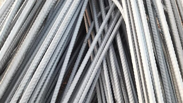 steel bars and reinforcement for building construction. A close-up view is suitable for the background. 
Bunch Of Iron Steel Rod Bar For Construction Building On Godown Or Warehouse