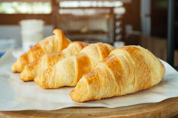 Freshly baked croissants from electric oven with smoke